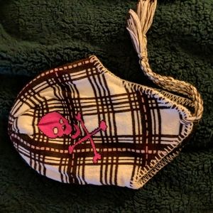 Dark brown and pink plaid hat with pink skull and crossbones